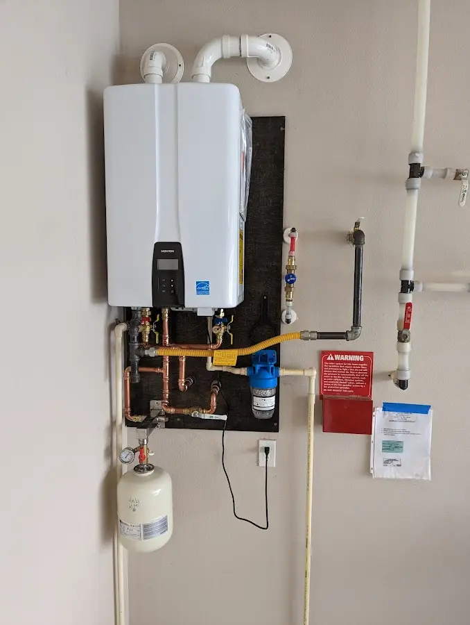 Professional plumber installing copper piping in a South Glens Falls home